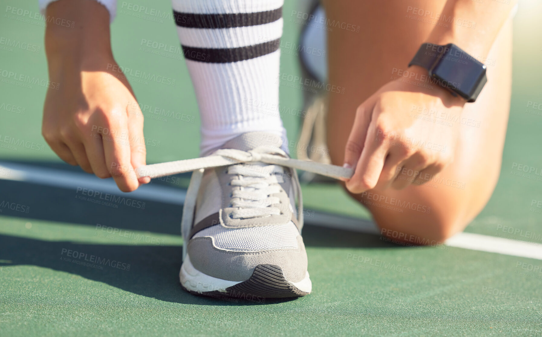 Buy stock photo Tennis player tie shoes before a game on the tennis court, ready to win. Female sports player tying shoelace on sneakers before tennis match. Training, exercise and having fun playing sport outdoors