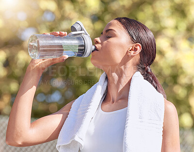 Buy stock photo Woman, exercise and drink water, while running or training outside in summer for fitness. Lady, workout and bottle for hydration in sun, runner and park on break with towel for health and wellness