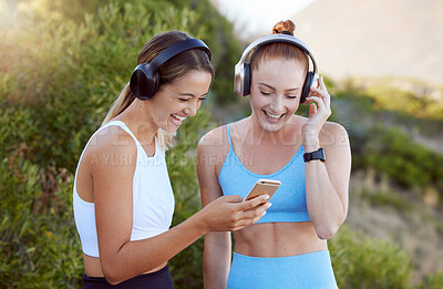 Buy stock photo Headphones, phone and fitness women in nature music, radio or audio streaming during exercise. Health, wellness and happy athlete girls on mobile, social media or 5g tech, workout app and training.