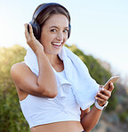 Fitness woman, wireless headphones and music streaming app on phone while outside with a smile during exercise, workout and training. Portrait of athlete woman with towel looking happy and healthy