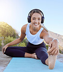 Workout stretch, music streaming headphones and woman outdoor on a yoga mat. Portrait of a happy smile from wellness, exercise and healthy stretching before training in nature by a mountain 