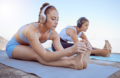 Buy stock photo Headphones, stretching and women in beach yoga for radio fitness, relax workout or zen exercise in nature. Friends, people or music for pilates training, chakra energy wellness or mental health peace