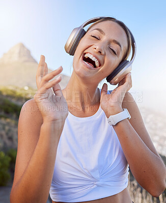Buy stock photo Fitness, headphones and woman outdoor listening to music for wellness podcast while training or doing workout exercise on blue sky and lens flare. Young person with 5g audio for exercise on mountain