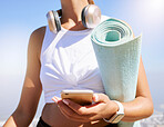 Fitness, yoga and woman on a phone in nature, texting and listening to music before summer outdoor workout. Radio, podcast and wellness exercise with female relax while searching for online playlist