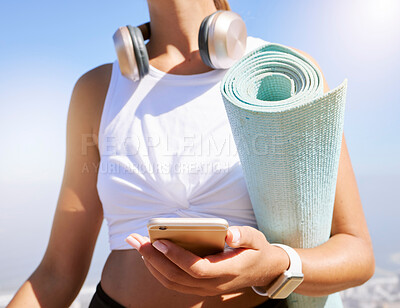 Buy stock photo Fitness, yoga and woman on a phone in nature, texting and listening to music before summer outdoor workout. Radio, podcast and wellness exercise with female relax while searching for online playlist