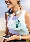 Relax, yoga mat and woman with mobile technology device with 5g connection for music streaming. Happy, healthy and fitness girl enjoying rest break in nature with smartphone and headphones.




