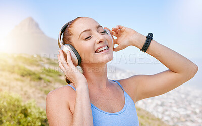 Buy stock photo Fitness, nature and a woman with headphones listening to music with smile and mountain background. Exercise, streaming app and a workout playlist online. Summer sky, sun and happy training with song.
