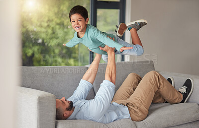 Buy stock photo Happy family, love and father and son bonding on a sofa at home, playing and being creative with a fun game. Energy, fantasy and airplane pose by happy boy enjoying free time with his caring dad