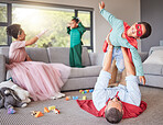 Family, parents and play costume with children for fun bonding and entertainment in home together. Excited, happy and young mother and father enjoy fantasy role play weekend game with kids.
