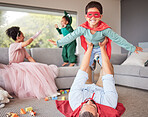 Happy parents and children in costume playing, bonding and having fun together in living room. Happiness, excited and family enjoying fantasy dress up for halloween entertainment with kids at home.