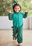 Creative, child and halloween costume by girl running in a crocodile suit, playing and laughing at home. Fantasy, happy and face of a kid excited to celebrate a fun festival, enjoying a break to play