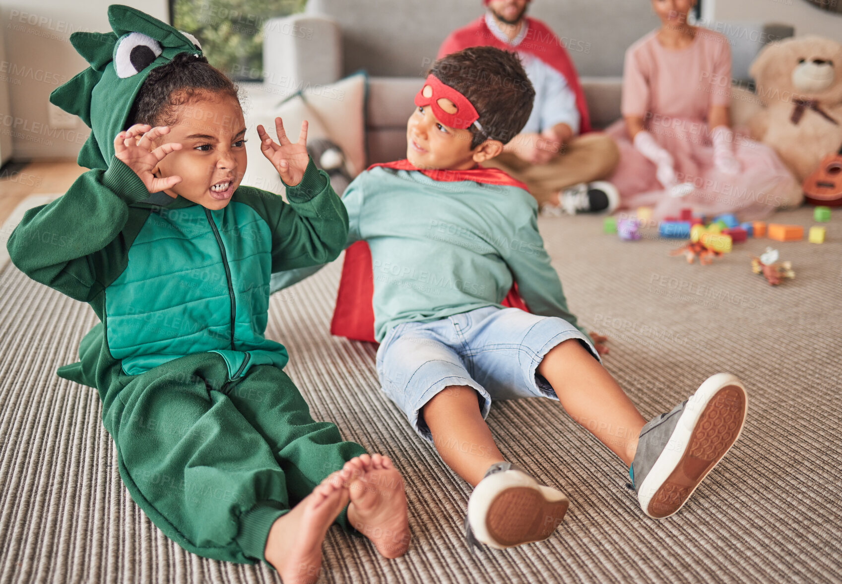 Buy stock photo Family, halloween and children playing in costume on a floor in a living room, having fun and being creative. Superhero, dinosaur and creative kids bonding in character, excited and happy together