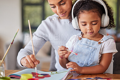 Buy stock photo Mother, girl and bonding in painting activity with music headphones, radio or audio for autism help. Brazilian woman, art parent and creative child listening to relax autism podcast in house or home