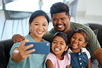 Family selfie, phone smile and parents happy with children on living room sofa, love on video call and relax with technology in house. Mother and father taking photo with girl siblings on tech