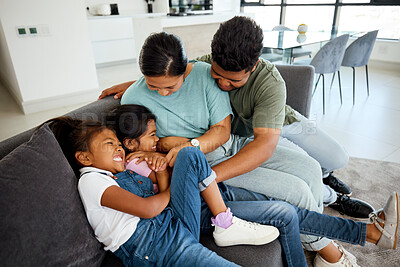 Buy stock photo Happy, laugh and play family smile in the lounge at home. Mother, father and young children playing, having fun and bonding. Parents teasing, joking and tickling their adorable and cute kids 