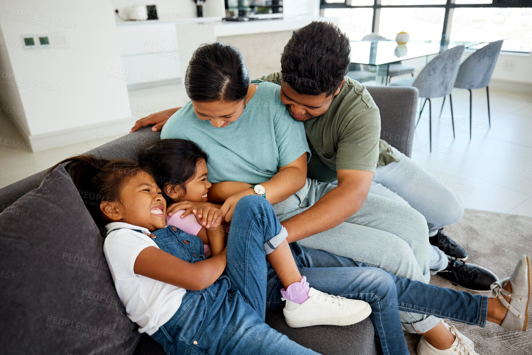 Buy stock photo Happy, laugh and play family smile in the lounge at home. Mother, father and young children playing, having fun and bonding. Parents teasing, joking and tickling their adorable and cute kids 