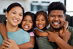 Family, smile and love of children for their mom and dad while sitting together in the lounge at home sharing a special bond. Portrait of happy Filipino man, woman and girl kids hugging their parents
