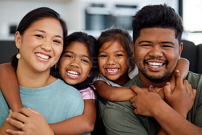 Buy stock photo Family, smile and love of children for their mom and dad while sitting together in the lounge at home sharing a special bond. Portrait of happy Filipino man, woman and girl kids hugging their parents