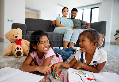 Buy stock photo Happy little children drawing with parents in the background at home living room. Kids enjoying quality time and creative art together while man and woman babysitting children in the living room