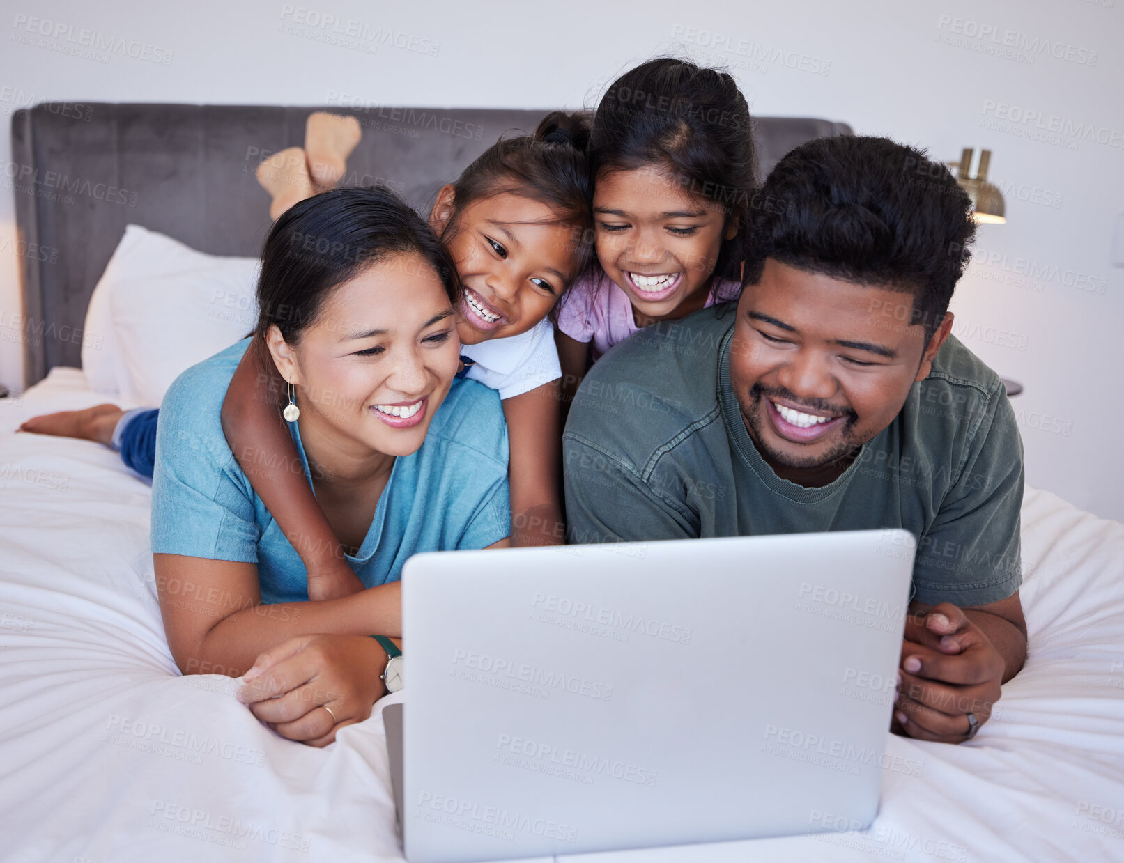 Buy stock photo Happy family, relax and laptop on a bed together, bonding and streaming online in a bedroom. Love, mother, father and children rest in their home together, enjoying subscription and entertainment