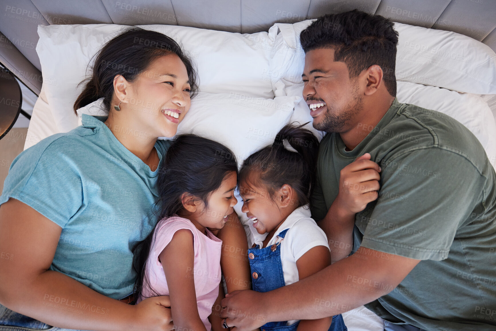 Buy stock photo Happy family, relax on bed in home from above and bonding together in bedroom. Sleep, comfort and rest of caring Indian mom, dad and children or girls smile lying on cozy sheets and playing in house.