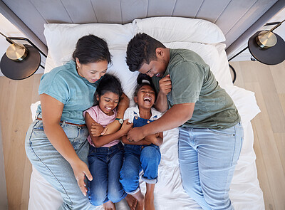 Buy stock photo Family bed, home relax and parents in bedroom with children, care for comic kids and love in house together from above. Top view of girl siblings laughing with happy mother and father in the morning