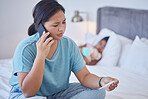 Covid, mother and child in bedroom with flu thermometer calling medical adviser or doctor. Anxious, worried and stressed Filipino mom on smartphone for healthcare advice and communication.