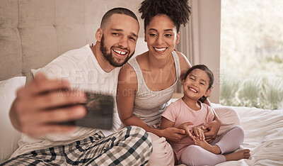 Buy stock photo Phone selfie of a relax happy family in bed, bond and enjoy quality time together in home bedroom. Love, morning and happiness for fun couple in pajamas bonding with adopted youth child, kid or girl