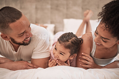 Buy stock photo Mother, father and girl in bed in house bedroom, home interior and bonding on a morning. Family smile, happy and love bond parents or man and woman with young child in security, support or trust
