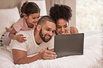Internet, laptop and relax with family in bedroom after wake up to watch movies, search or streaming service. Technology, digital and smile with parents and girl at home with online subscription