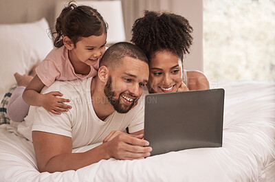 Buy stock photo Internet, laptop and relax with family in bedroom after wake up to watch movies, search or streaming service. Technology, digital and smile with parents and girl at home with online subscription