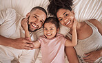 Family happy, child and above bed with parents in the morning, funny face in house and comic after sleeping together in home. Portrait of happy mother and dad smile with girl kids in home bedroom
