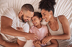 Morning, love and parents relax on bed with happy daughter together in house while laughing. Cheerful mother and father of young child smile in family home bedroom in Mexico top view.


