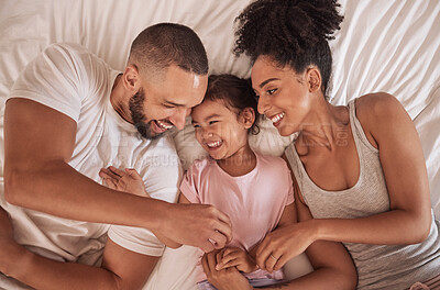 Buy stock photo Morning, love and parents relax from above on bed with happy daughter together in Mexican house. Cheerful mother and father of young child smile in family home while resting in bedroom.


