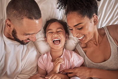 Buy stock photo Children, family and bedroom with a girl, mother and father laughing, joking or tickling in bed from above. Kids, happy and love with a woman, man and daughter having fun together in their home