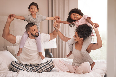 Buy stock photo Happy, family on bed relax, excited and bonding in the morning in their pajamas in family home. Young, black parents and daughters in bedroom being carefree, showing affection and rest together