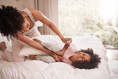 Buy stock photo Morning, happy family and mother with child play pillow fight together in house bedroom in Mexico. Caring, cheerful and smiling Mexican daughter with mom tickling her on bed to bond in home.
