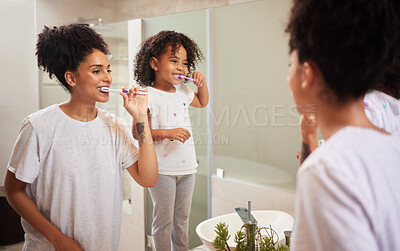Buy stock photo Mirror reflection of mom and girl brushing teeth together while bonding, having fun and enjoy quality time. Child development, learning or dental care for oral hygiene girl cleaning teeth in bathroom
