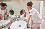 Child, dental and toothbrush with a girl and her mother brushing their teeth together in the bathroom of their home. Family, hygiene and oral with a woman and daughter practicing care and hygiene