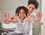 A mom teaching child to clean their hands, using soap and water in the bathroom to destroy germs to stay healthy. Dirty hands spread virus, bacteria or disease to the family and be a health risk