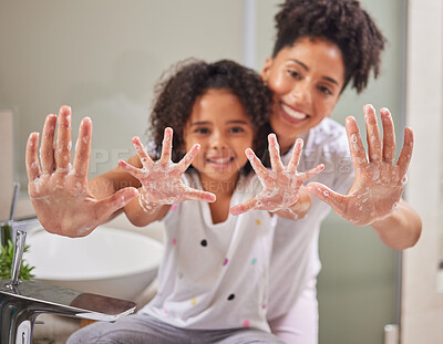 Buy stock photo A mom teaching child to clean their hands, using soap and water in the bathroom to destroy germs to stay healthy. Kid washing dirty hand, keeps family health safe and prevent dangerous bacteria