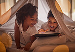 Little children, tablet and streaming online for movies, cartoon or educational games before bedtime at night in blanket fort with a fun app. Boy and girl kid sharing, reading and internet addiction