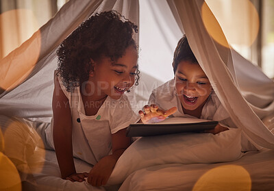 Buy stock photo Children, tablet and night streaming online for movies, cartoon or educational games before bedtime in a blanket fort with a fun app. Excited boy and girl kid sharing, reading and internet addiction
