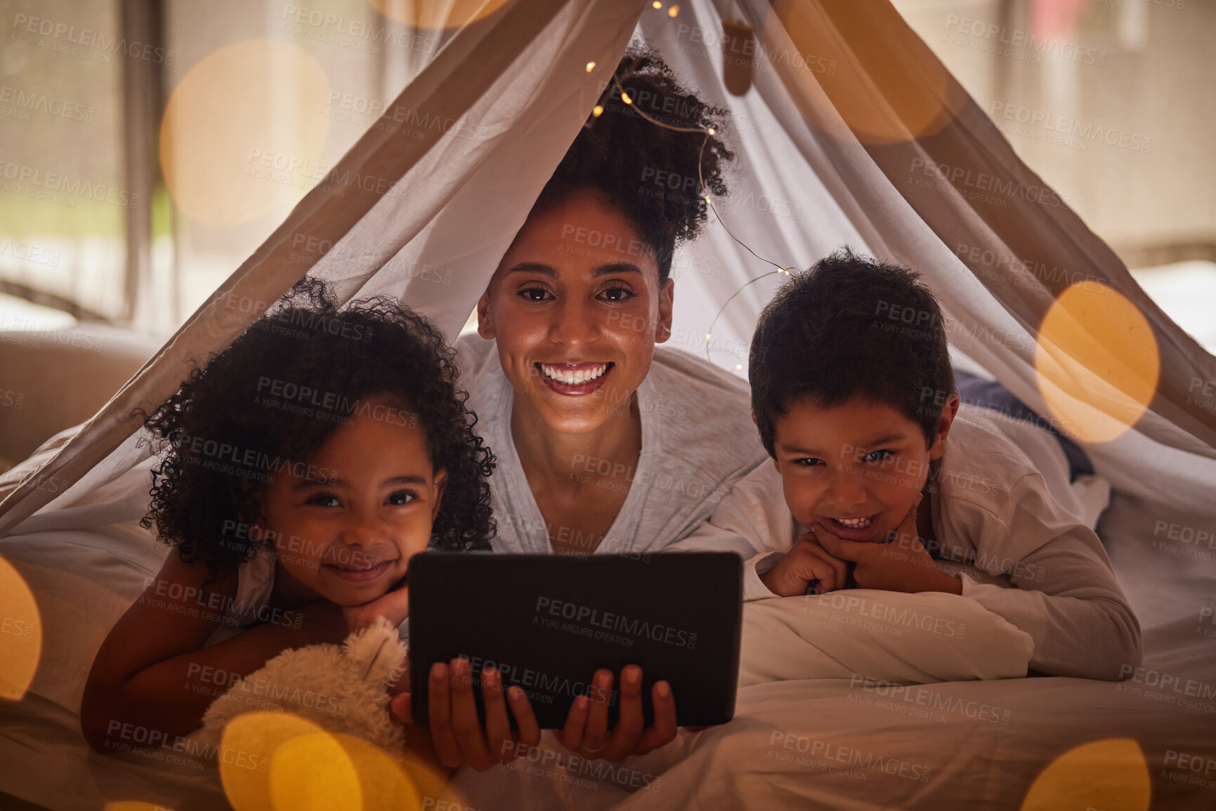 Buy stock photo Family portrait, tablet and online app for kids cartoons, streaming and digital night story in blanket fort tent at home. Happy Brazil mother, smile children and reading, playing on internet tech