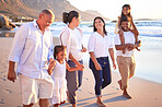 Big family, children and beach vacation with parents and grandparents enjoying summer travel on fun on tropical trip. Walking, bonding and happy men, women and girl kids on South Africa holiday
