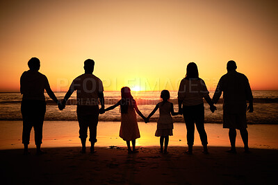 Buy stock photo Big family silhouette on beach with sea waves, sunset on the horizon and holding hands for development wellness, support and love. Children and group of people watch ocean on dark, orange sky mockup