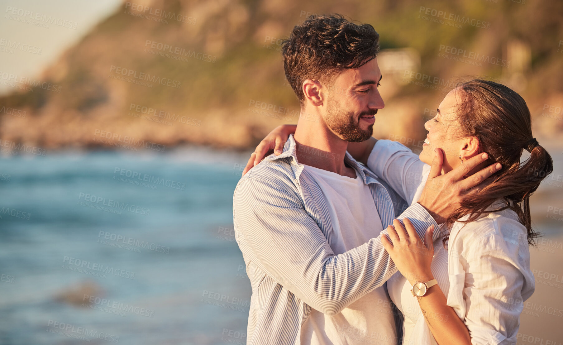 Buy stock photo Love, beach and couple embrace at sunset for romantic summer evening date together in nature. Happy, sweet and satisfied people in relationship make eye contact for affection and care. 

