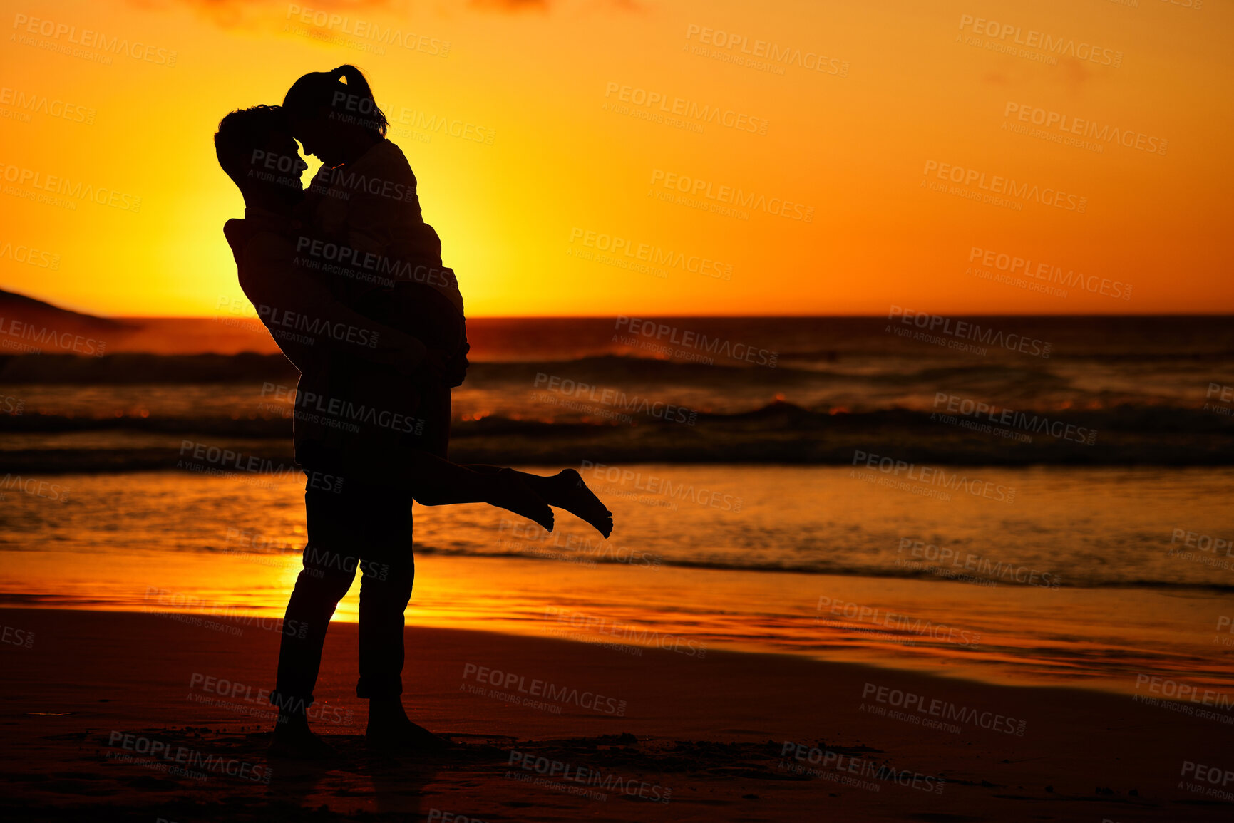 Buy stock photo Couple, beach and sunset with a man and woman hugging on the coast with a golden view in the background. Love, silhouette and ocean with a male and female embracing on the sand by the sea for travel 