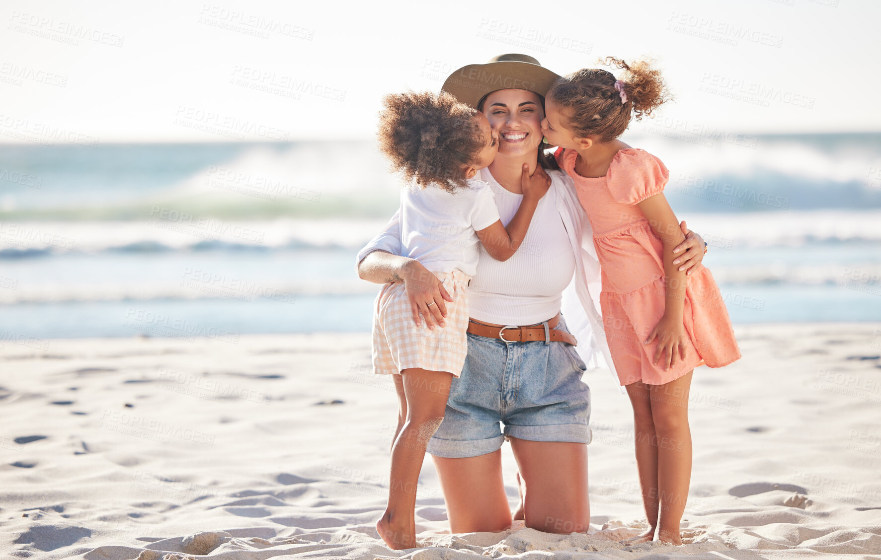Buy stock photo Mom, kiss or children bonding on beach in Portugal in trust, security or love hug. Smile, happy or support parent with girls, kids or family on relax holiday, mothers day or summer break by ocean sea
