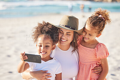 Buy stock photo Mom, children and beach with phone for selfie in the sunshine while on holiday together. Mother, kids and ocean  take photo with smartphone in the sun on vacation or family travel to the sea